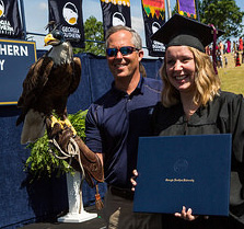 Photo of a graduate with her diploma